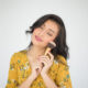 young beautiful woman touch with powder brush white background 80x80